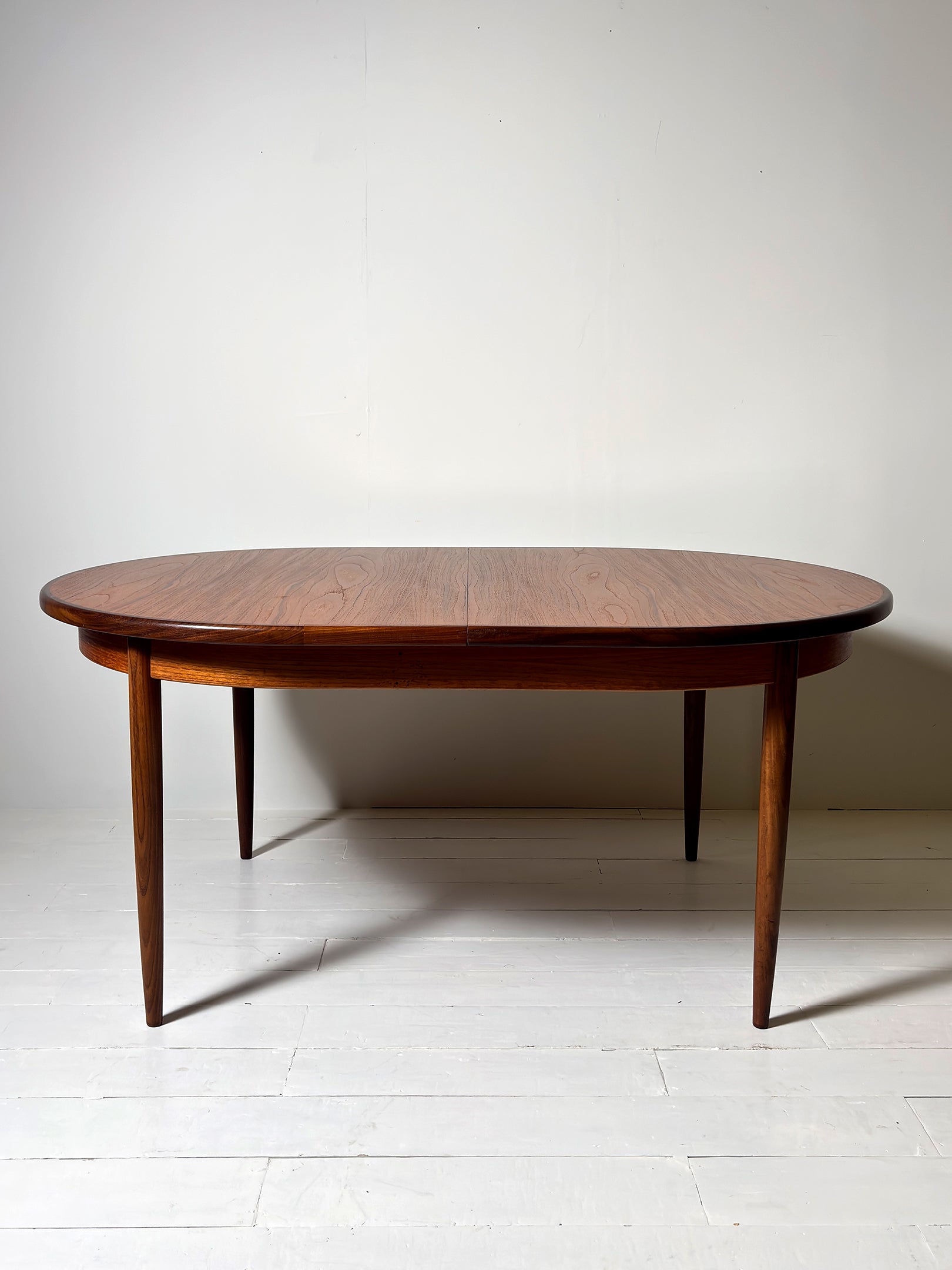 G Plan teak extendable dining table from 1960s showing grain detail" or "Mid-Century G Plan dining table extended with leaves inserted. not Extended. Teak. Great condition. 