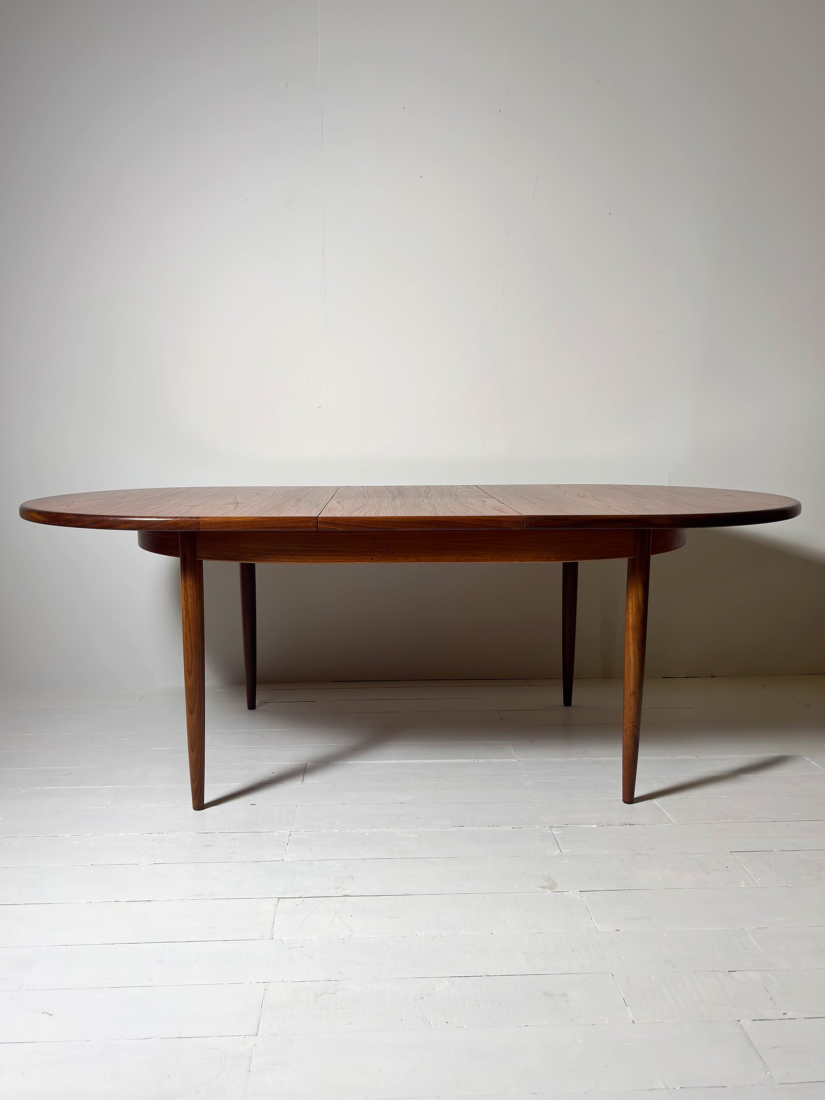 G Plan teak extendable dining table from 1960s showing grain detail" or "Mid-Century G Plan dining table extended with leaves inserted. Extended. Teak. Great condition.