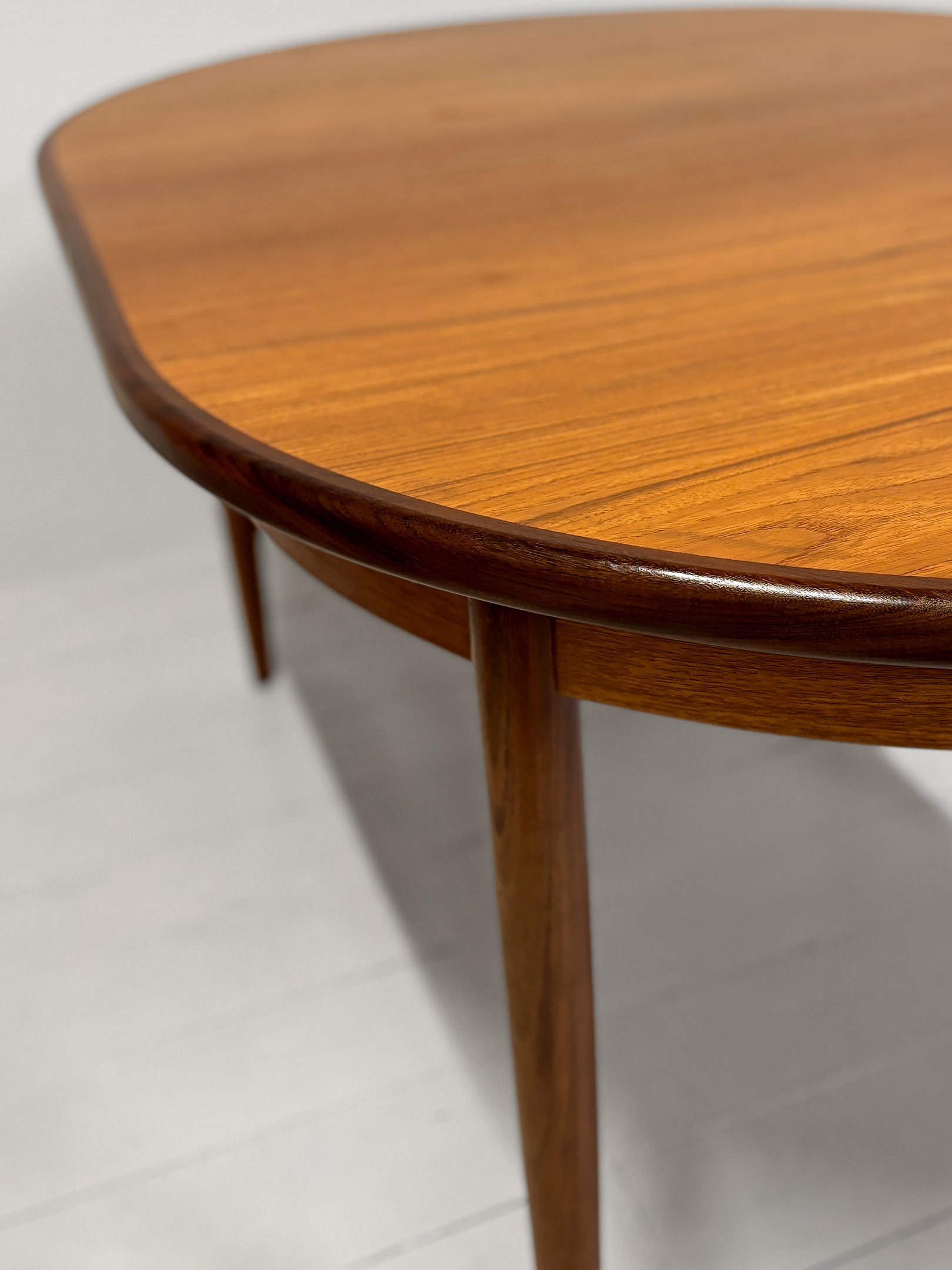 G Plan teak extendable dining table from 1960s showing grain detail" or "Mid-Century G Plan dining table extended with leaves inserted. Extended. Teak. Great condition. 